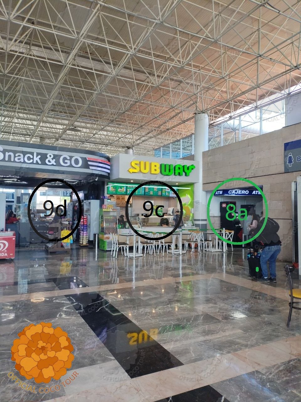 A line of white taxis with orange stripes waiting under the canopy outside Morelia bus station